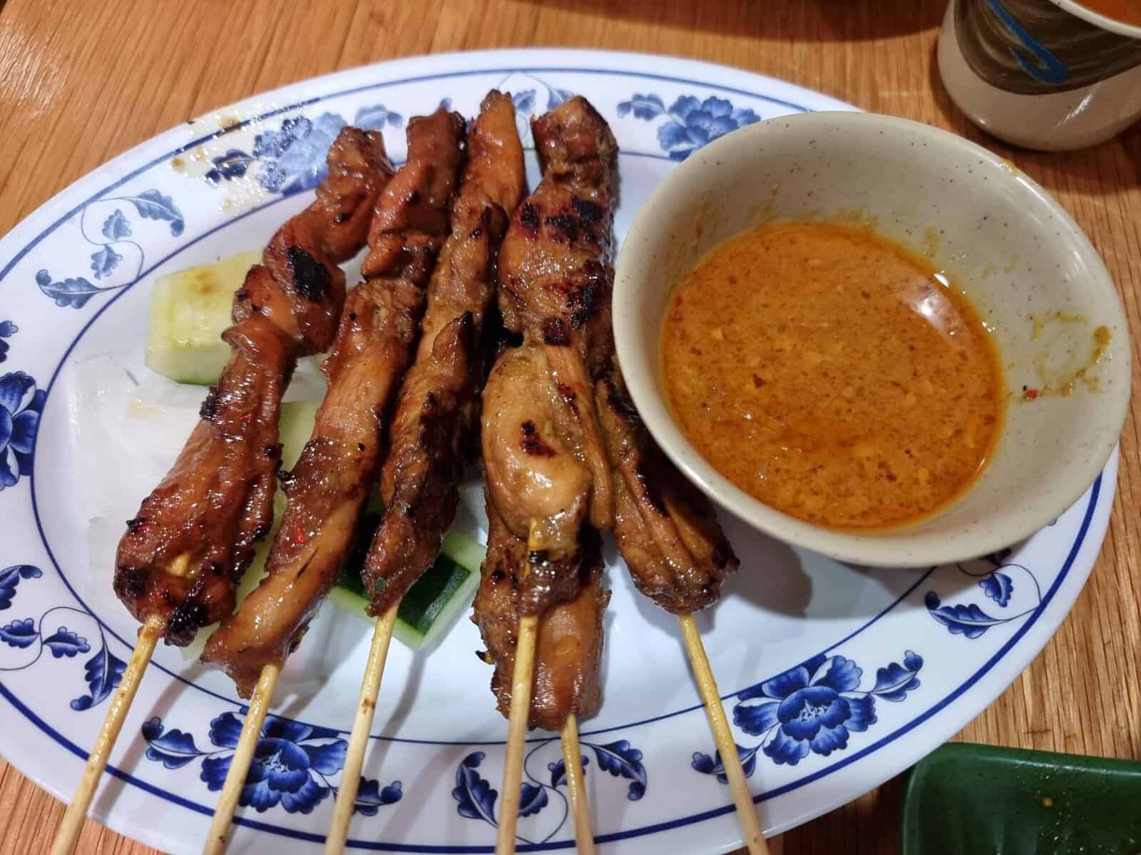 Grilled chicken satay skewers served with a thick peanut dipping sauce