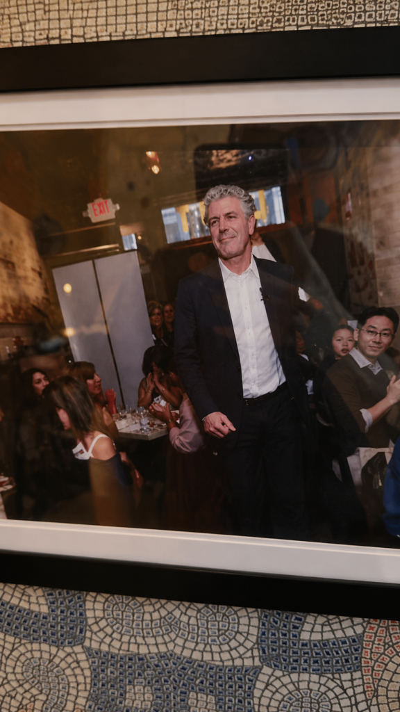 Framed photo of Anthony Bourdain smiling inside Laut restaurant in New York City
