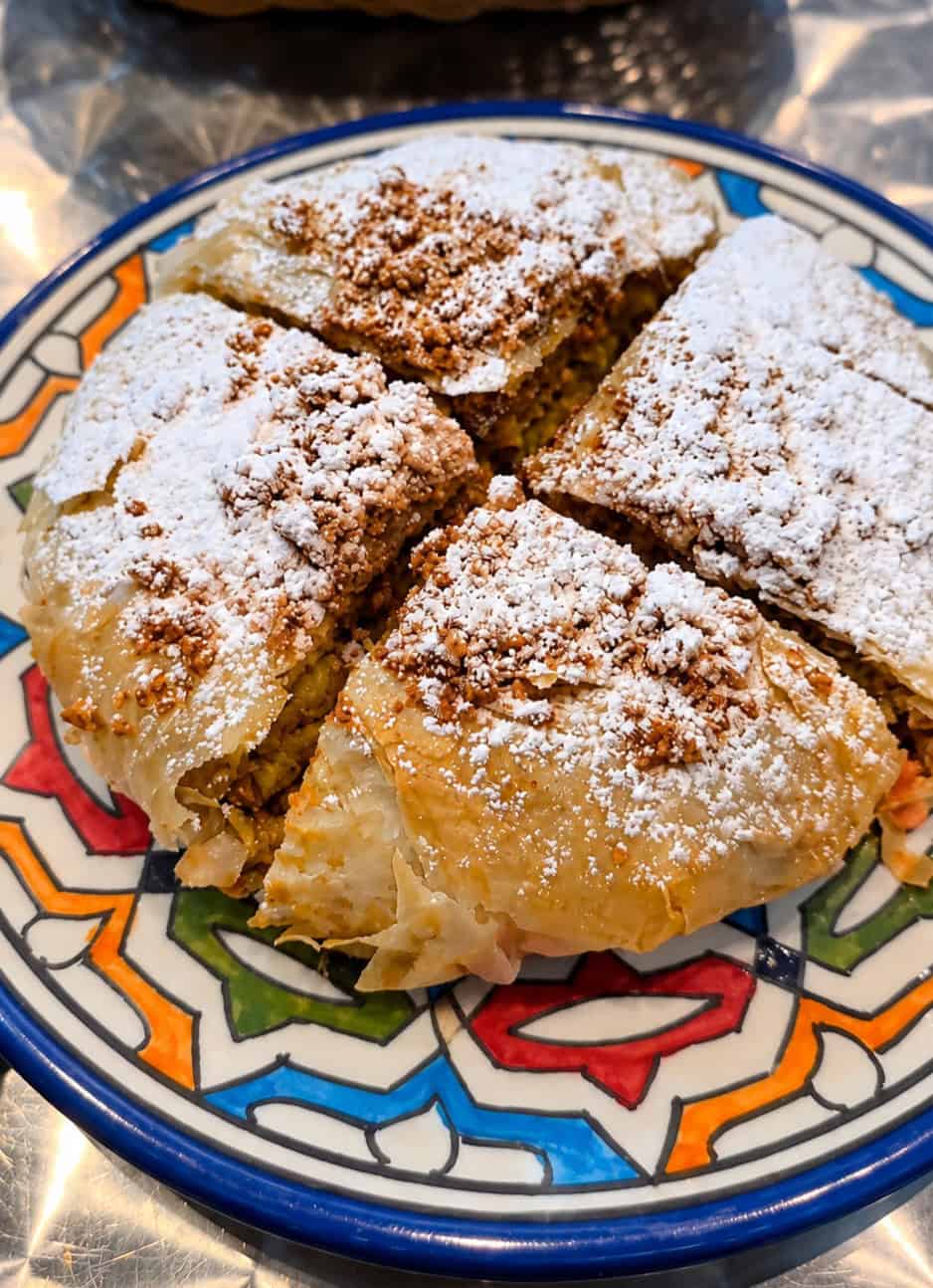 Chicken Pastilla topped with powdered sugar at Moroccan Bites by Siham in Astoria