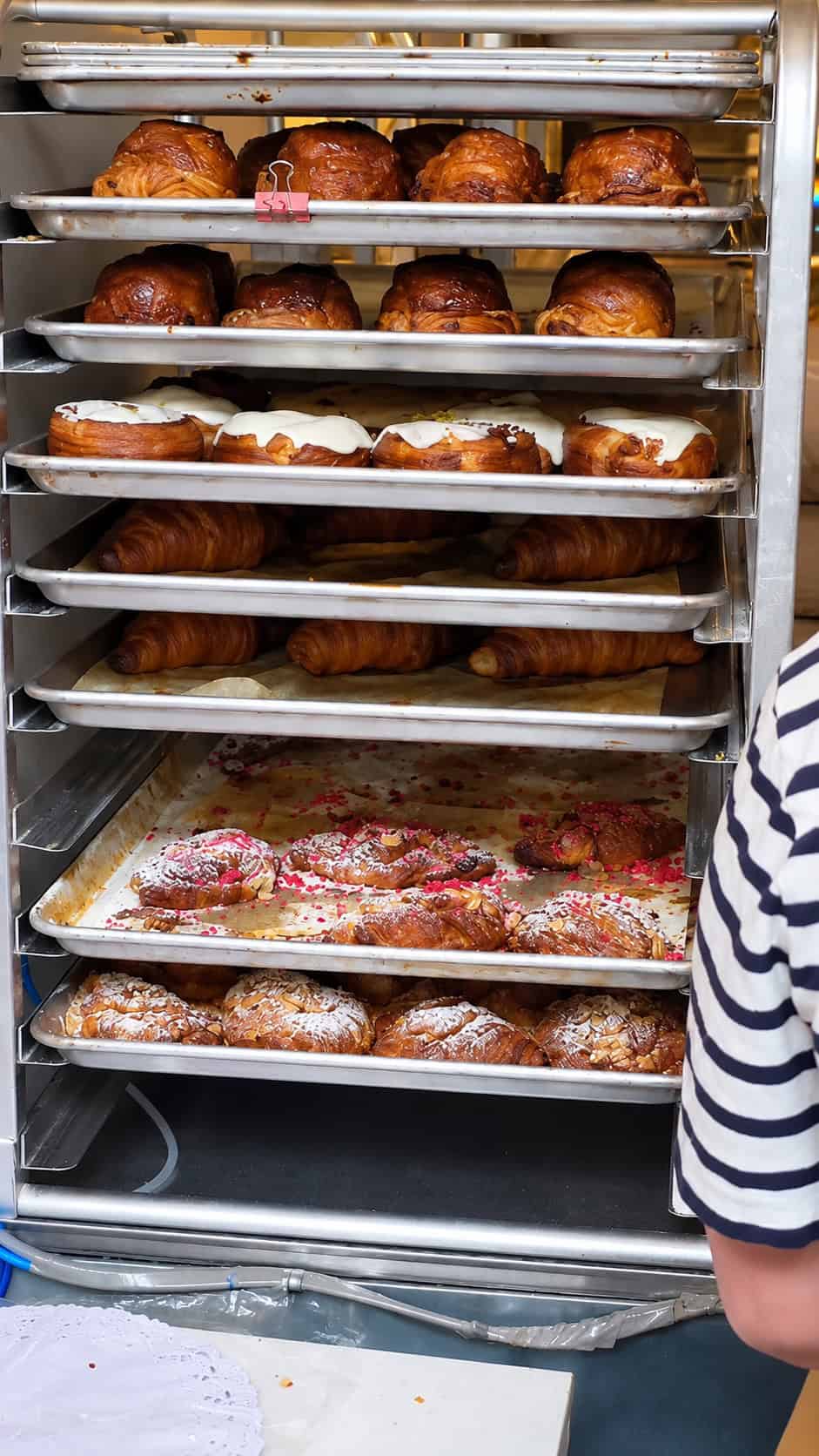 Fresh croissants and pastries on racks at L'Appartement 4F in Brooklyn Heights