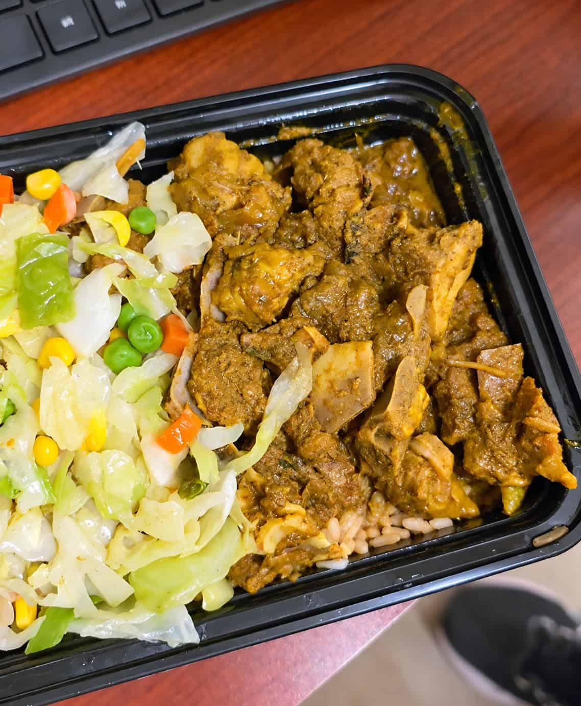 Jamaican curry goat served with rice and peas and mixed vegetables from Robinson Valley tent
