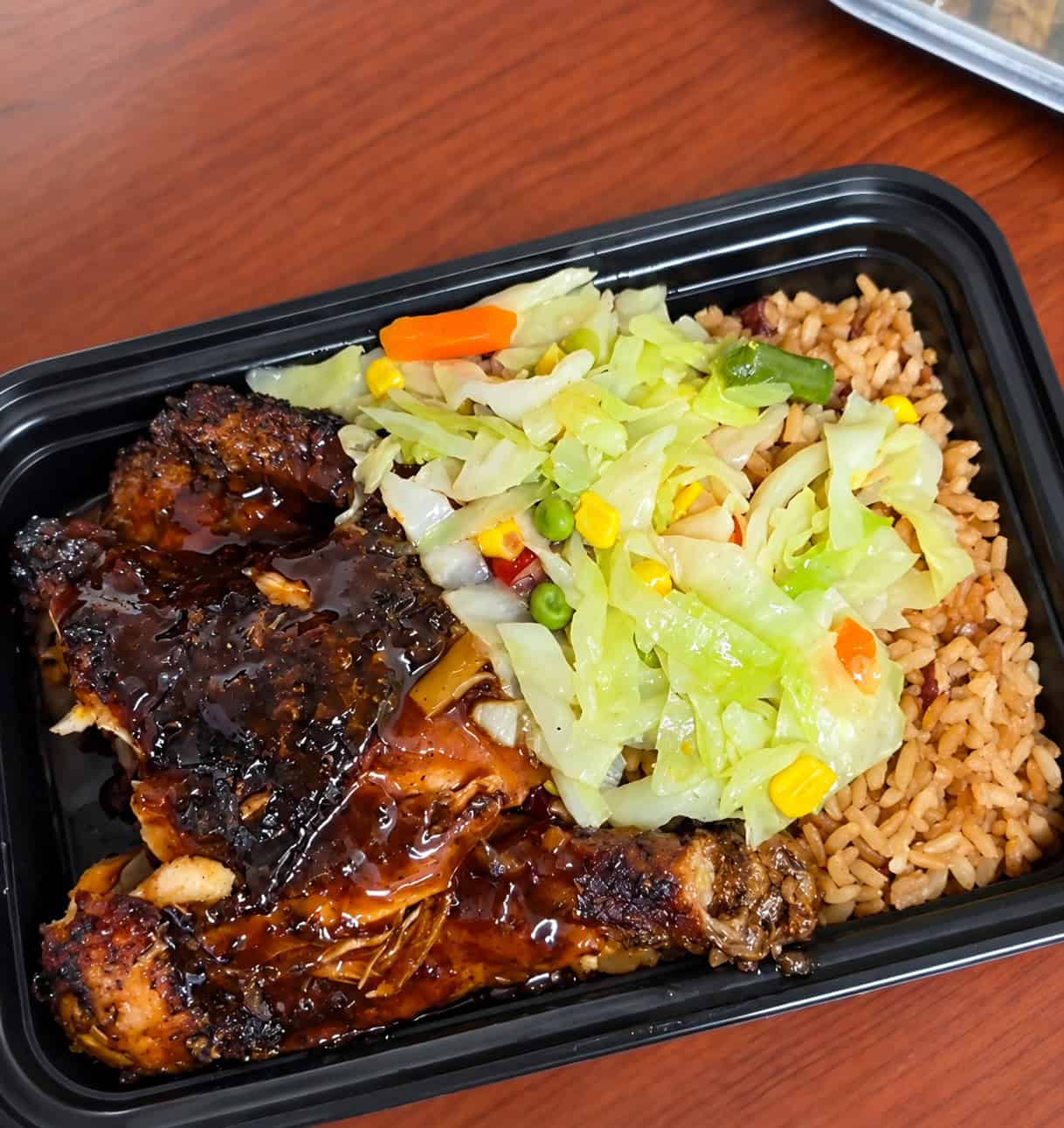 Jerk chicken plate with dark sauce, rice and peas, and steamed vegetables from Robinson Valley