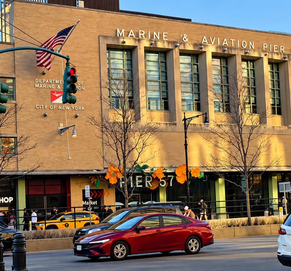 Exterior view of historic Marine and Aviation Pier 57 building with yellow brick facade on the Chelsea waterfront in Manhattan