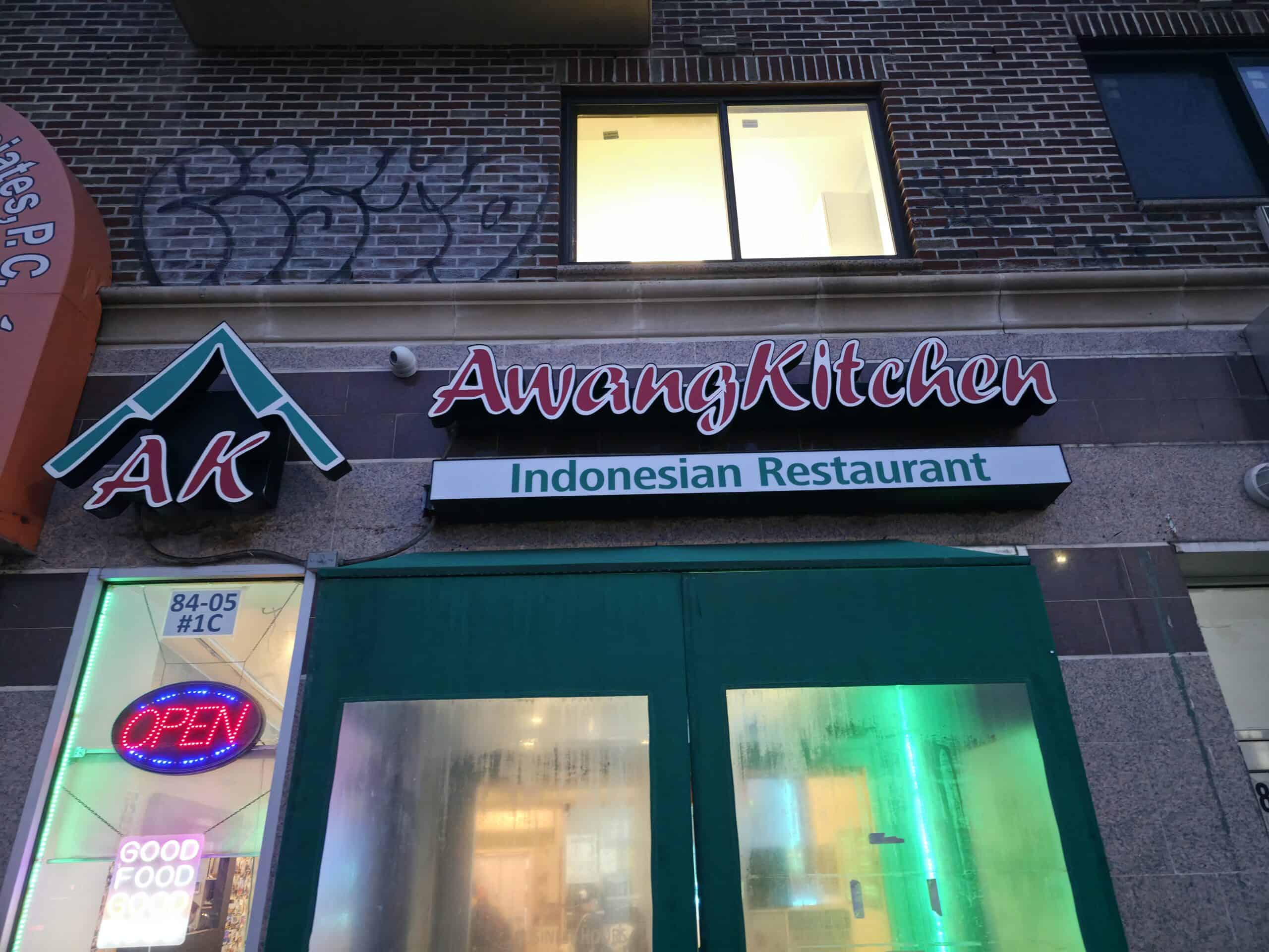 Exterior storefront and illuminated sign of Awang Kitchen Indonesian Restaurant on Queens Boulevard in Elmhurst Queens