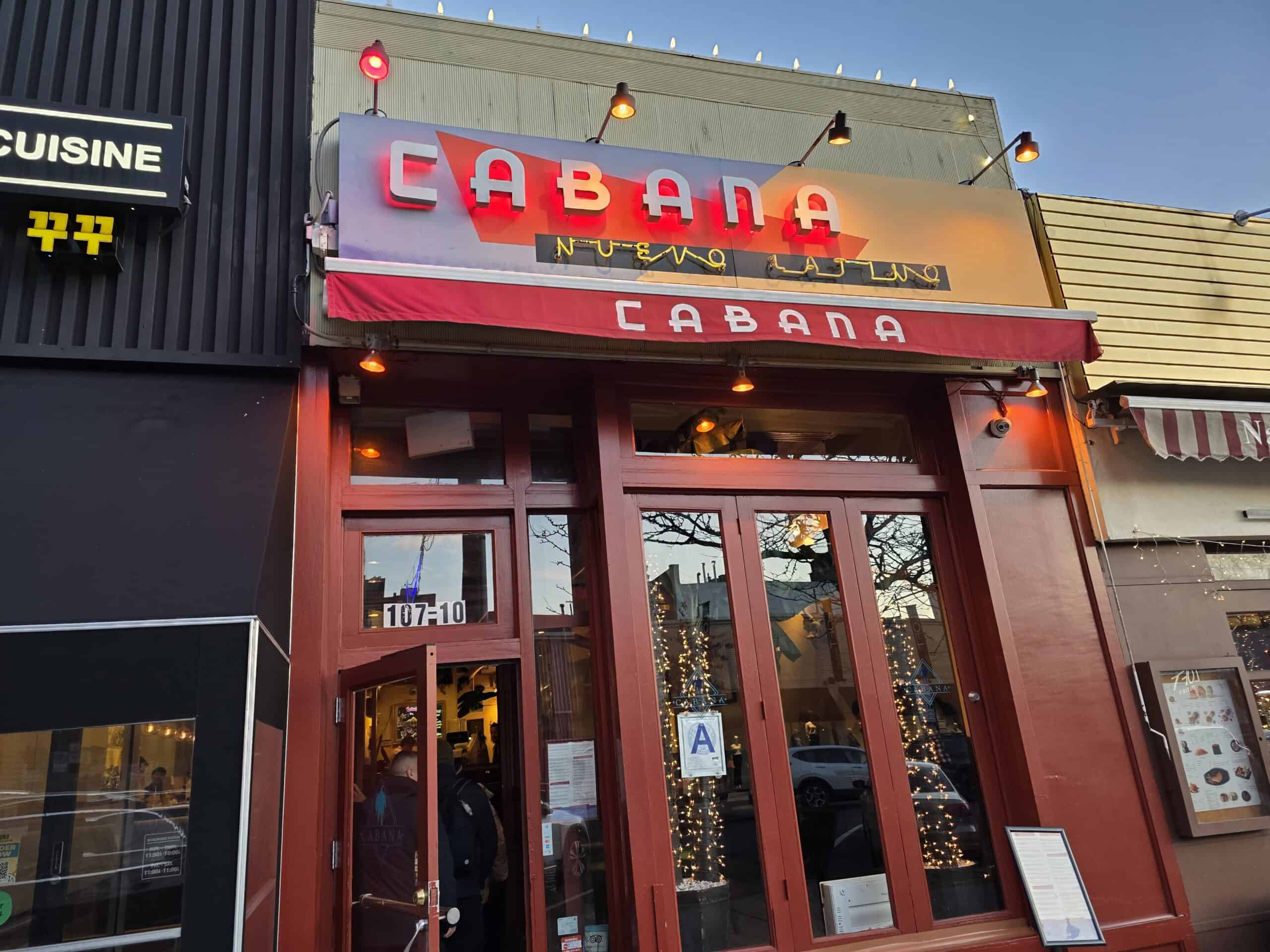 Red wooden storefront exterior and illuminated neon sign for Cabana Nuevo Latino restaurant on 70th Road in Forest Hills Queens