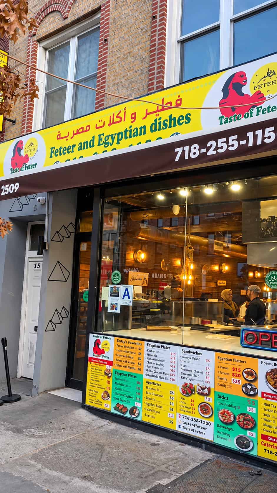 Exterior storefront and yellow banner of Cairo Feteer restaurant on Steinway Street in Astoria Queens