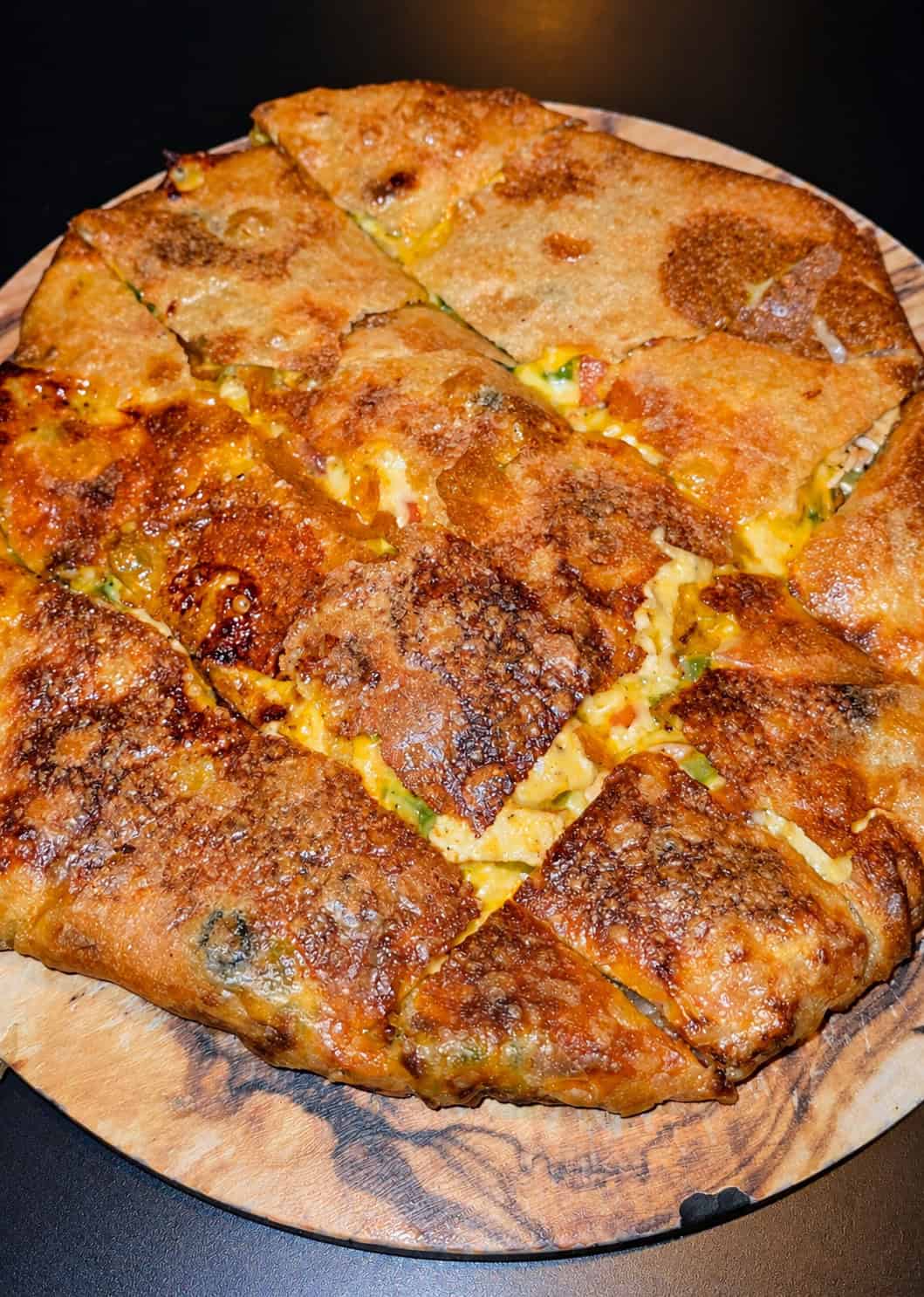 Sliced Chicken Fajita Feteer displaying golden flaky pastry layers stuffed with melted cheese and peppers