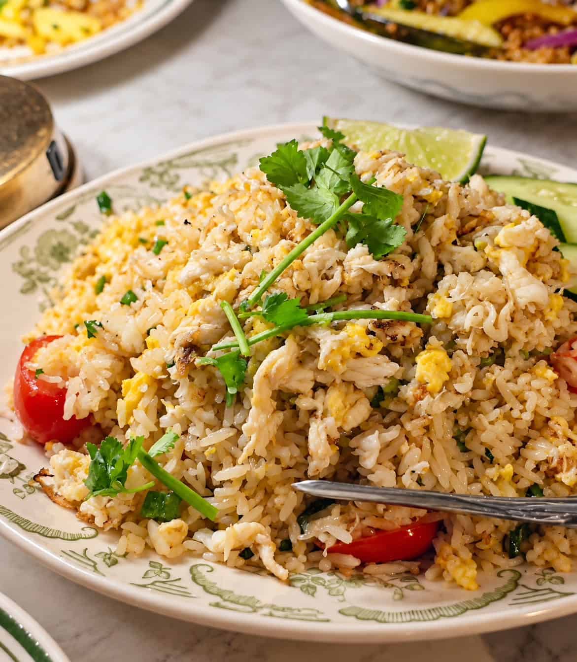 Plate of Crab Meat Fried Rice generously loaded with sweet lump crab meat cilantro and lime