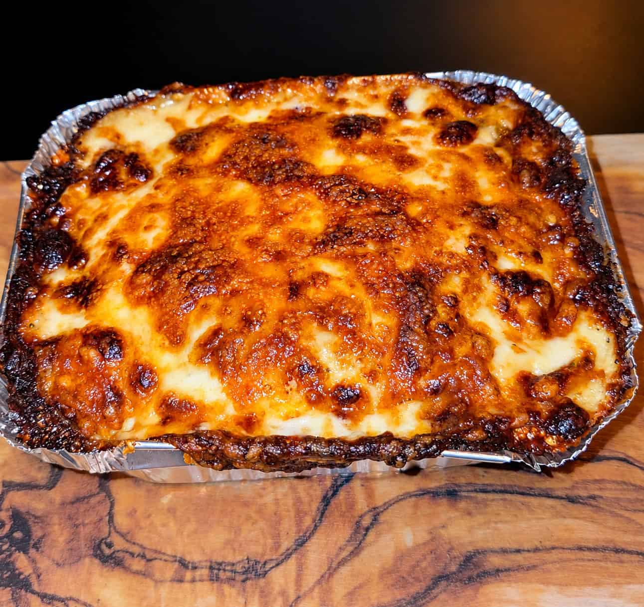 Golden baked Egyptian béchamel pasta tray with a crispy browned cheese top layer at Cairo Feteer