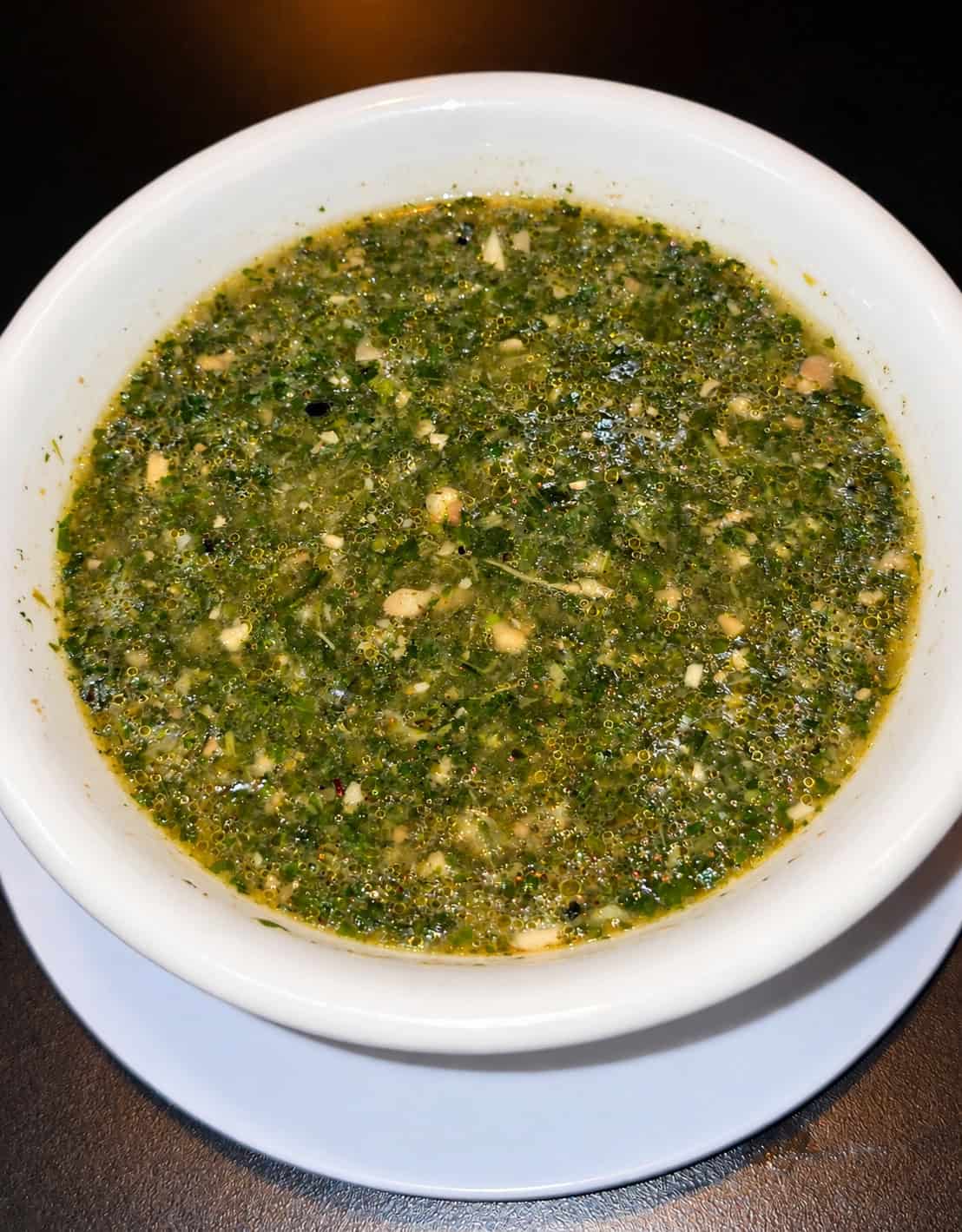 Bowl of traditional Egyptian Molokhia green jute mallow leaf soup simmered with garlic and coriander