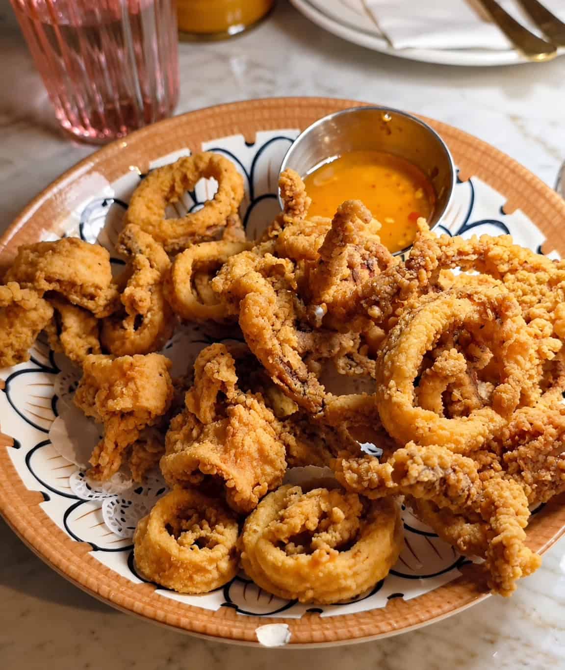 Golden crispy fried calamari rings and tentacles served with sweet chili dipping sauce