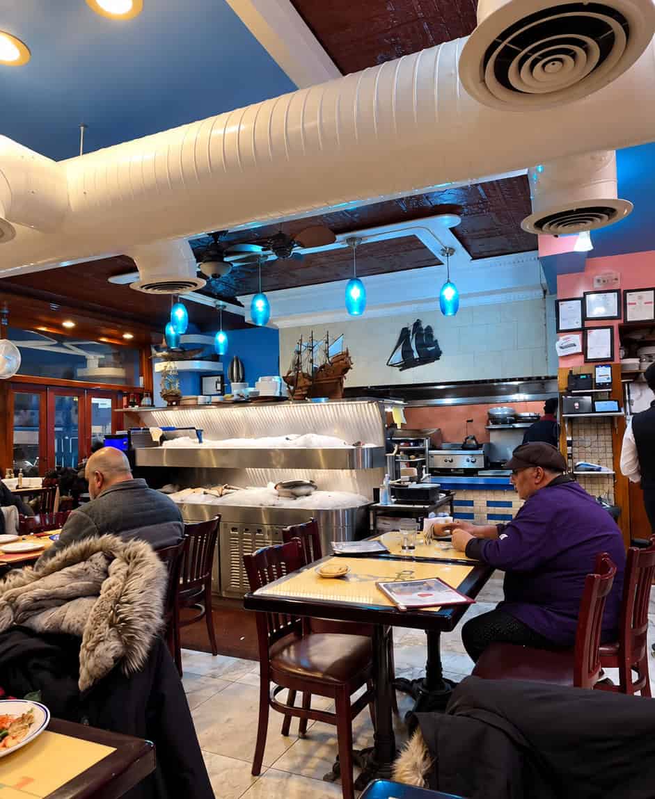 Casual interior dining room at Sabry's Seafood with nautical decor and fish display counter