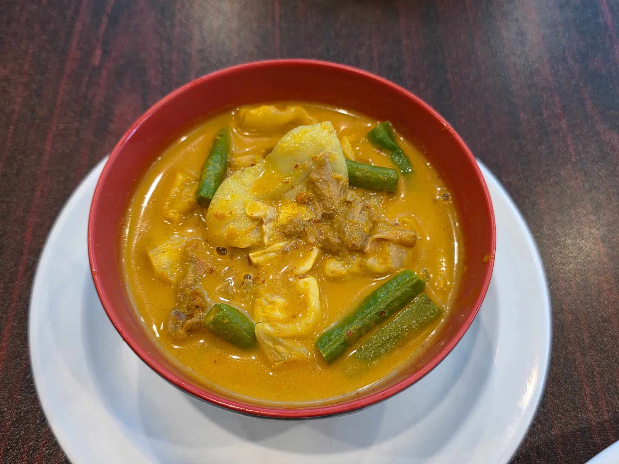 Bowl of Sayur Gulai Nangka young jackfruit and green beans in a rich coconut curry sauce
