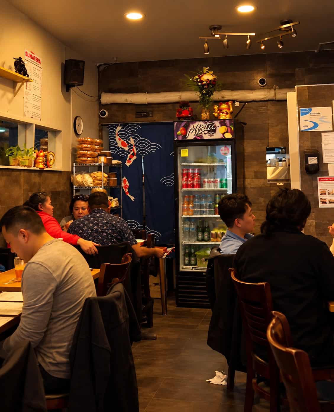 Small crowded dining room inside Sumatera Restaurant NYC in Elmhurst